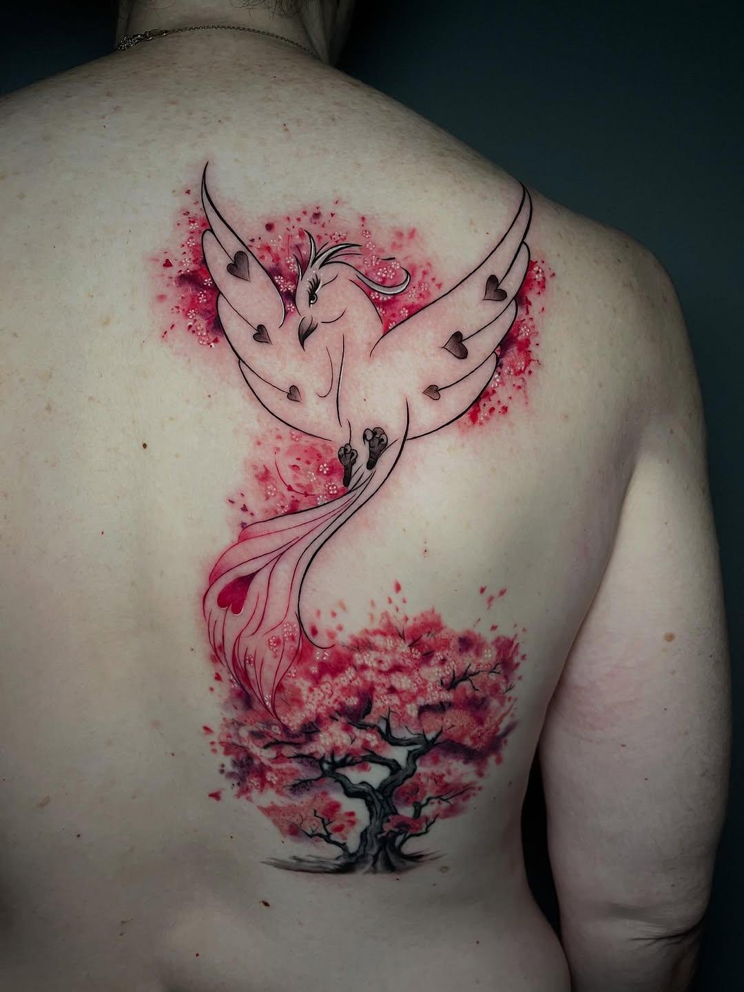Tatouage oiseau ailes arbre fleuri — theatattoo06