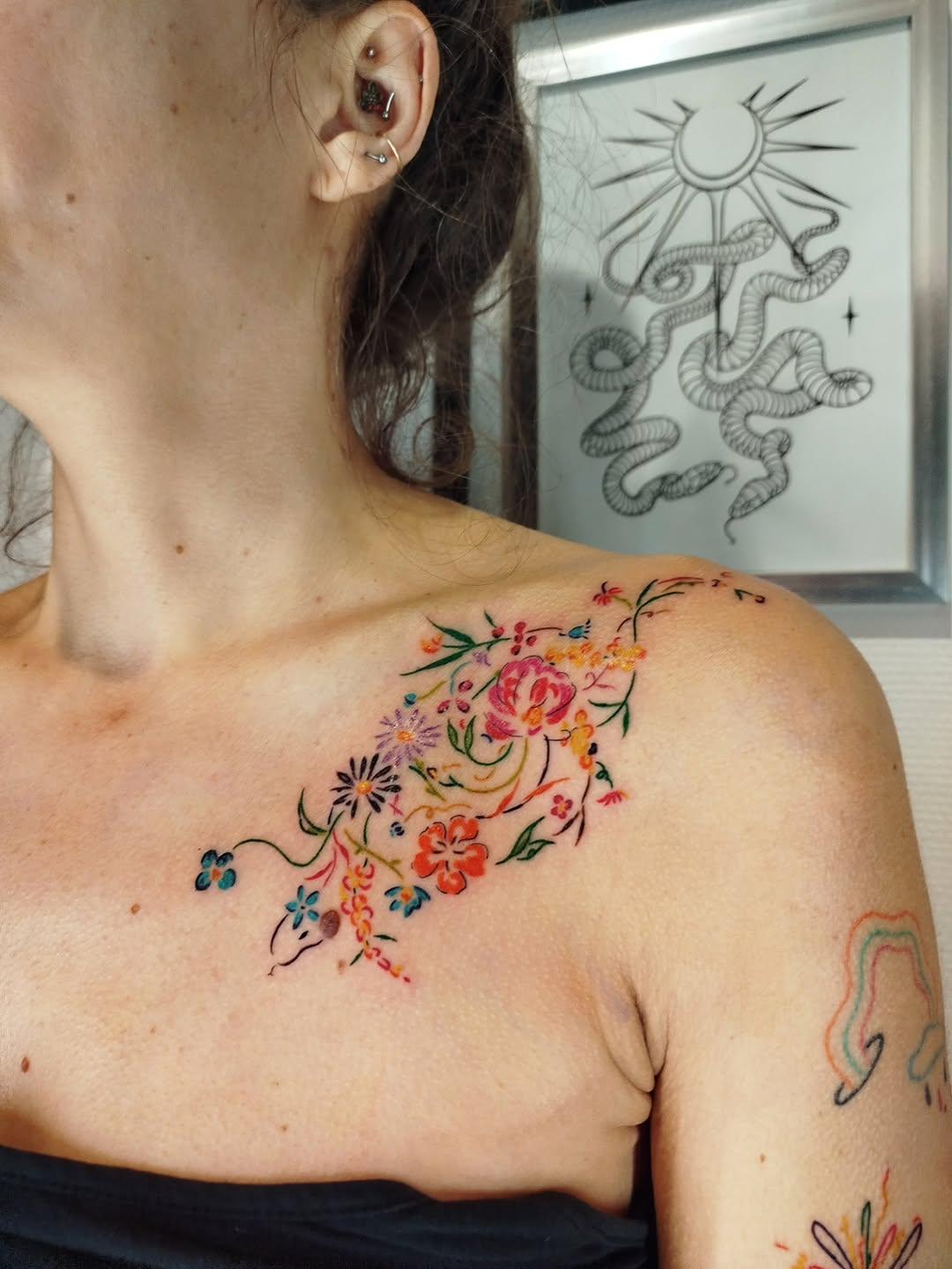 Serpent fleuri coloré tatouage bras